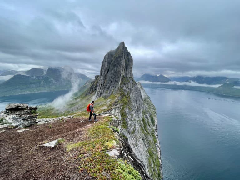 Hiker on the Segla ridge above Bergsfjord on Senja