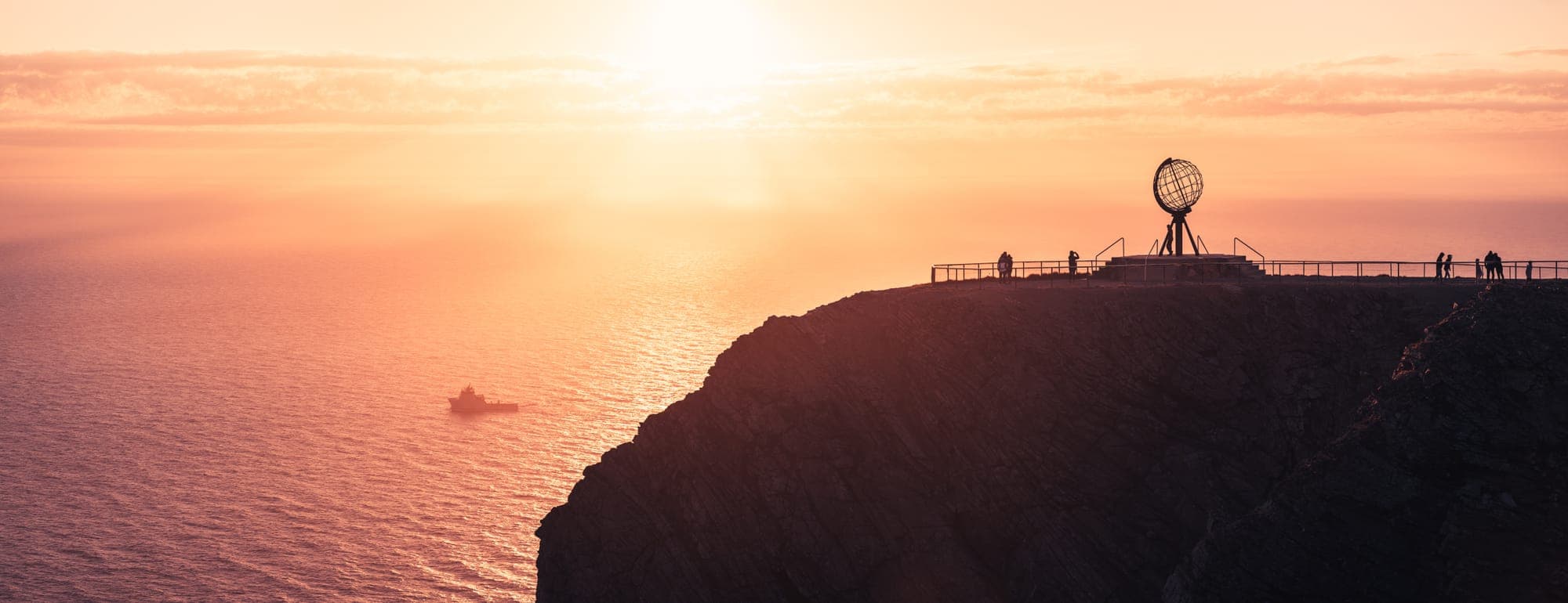 North Cape plateau and globe monument at midnight sun, Nordkapp, Norway