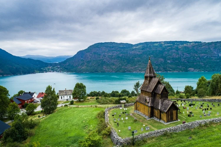 Urnes Stave Church on a hillside above Lustrafjord with dragon-head gables