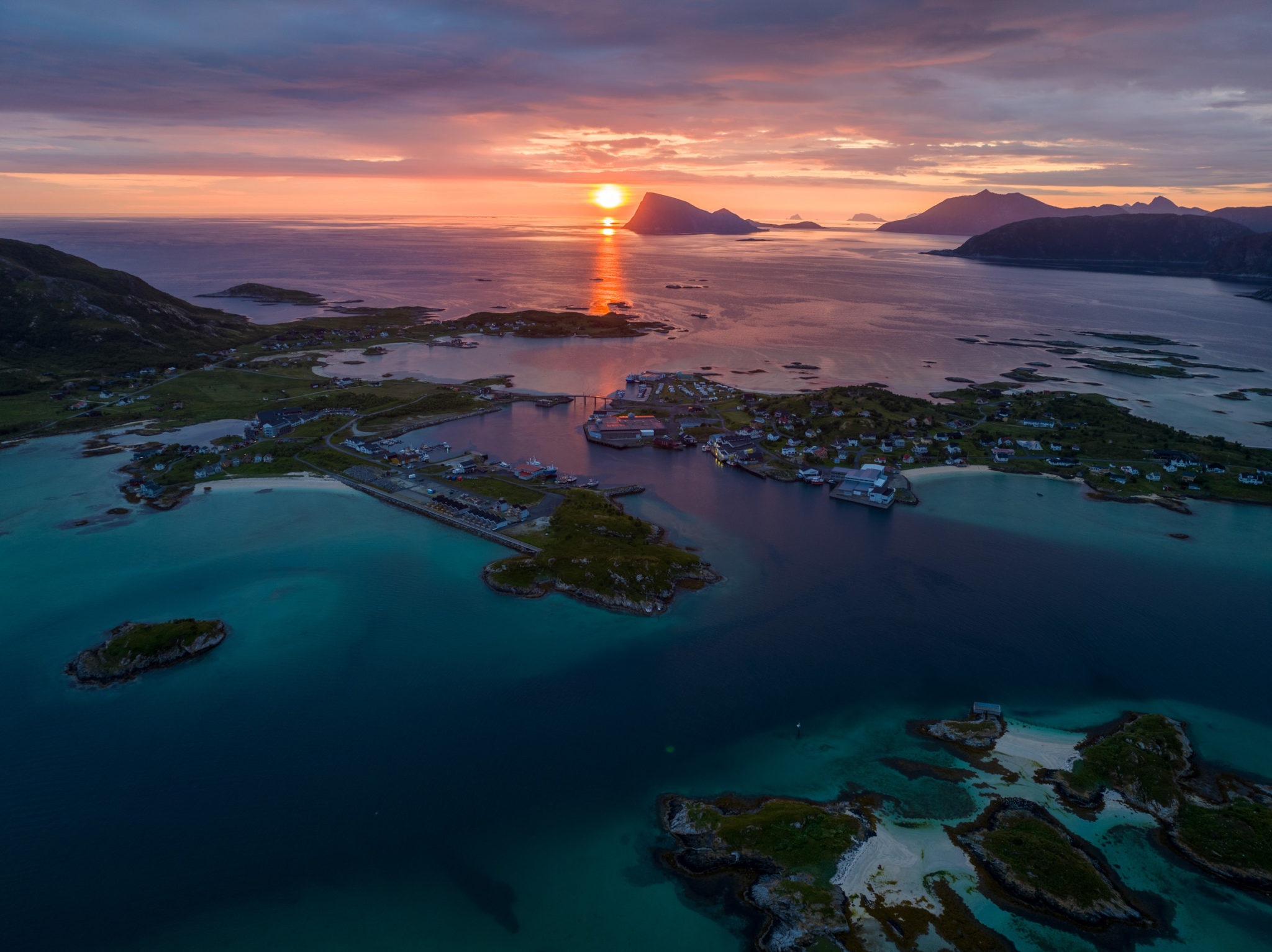 Midnight sun over Sommarøy islands and turquoise Arctic waters near Tromsø in June